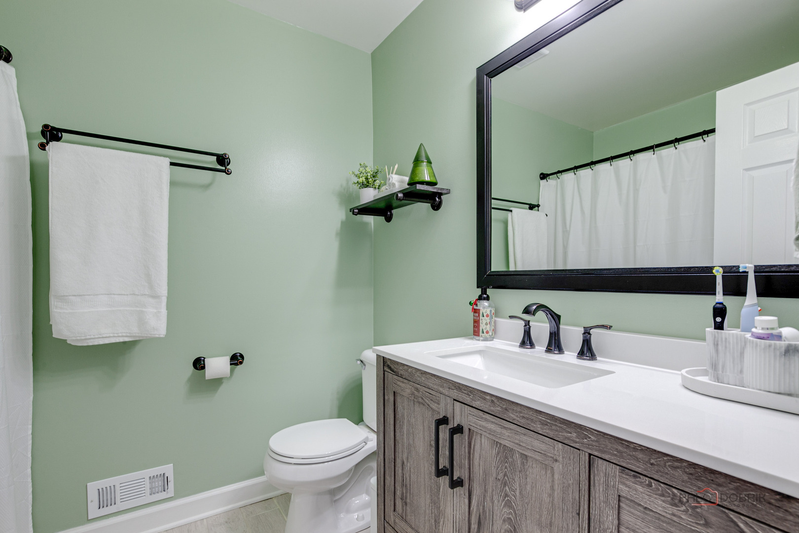 1502 Anderson Trail Zion, IL 60099 - Photo 20 of 30 a bathroom with a sink a toilet and a mirror