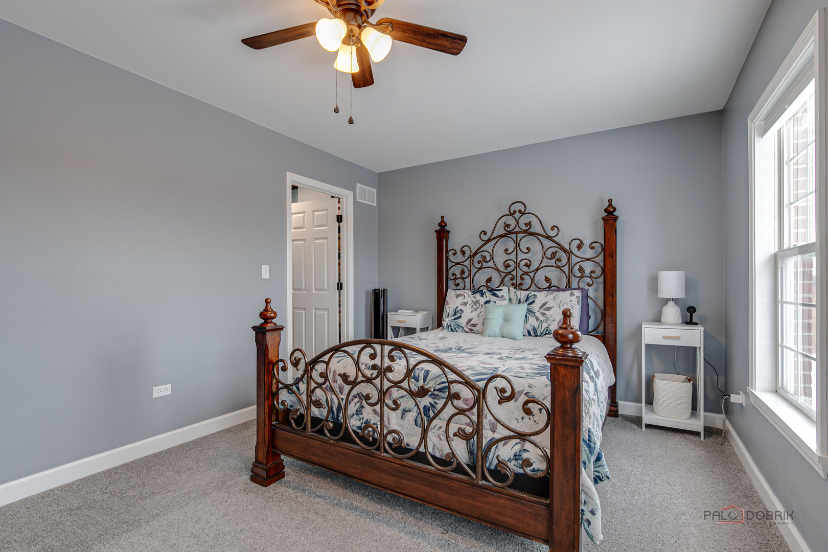 1502 Anderson Trail Zion, IL 60099 - Photo 22 of 30 a bedroom with a bed and a chandelier