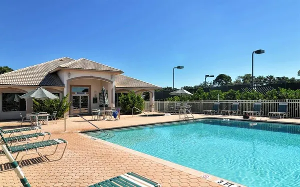 a view of a house with swimming pool and sitting area