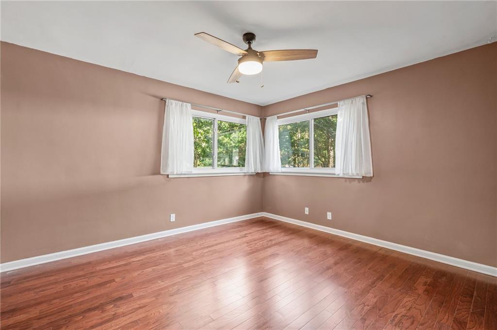 20 26th Street Northwest, Unit A1 Atlanta, GA 30309 - Photo 12 of 19 an empty room with wooden floor and windows