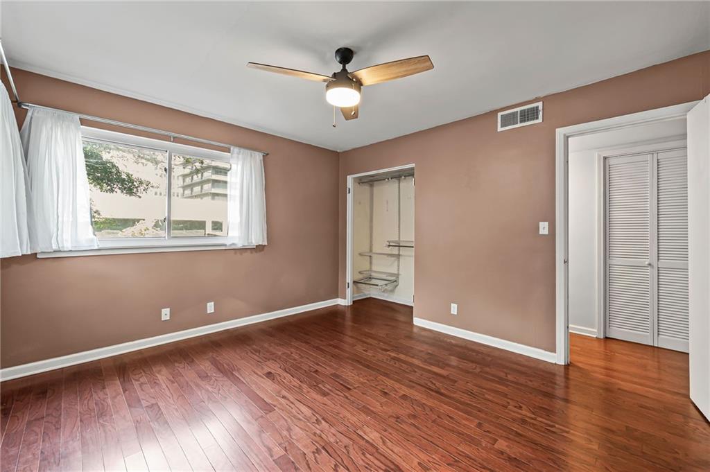 20 26th Street Northwest, Unit A1 Atlanta, GA 30309 - Photo 13 of 19 an empty room with wooden floor and windows