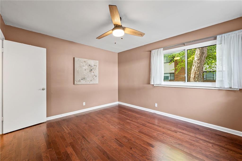 20 26th Street Northwest, Unit A1 Atlanta, GA 30309 - Photo 15 of 19 a view of an empty room with wooden floor and a window