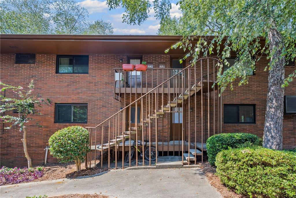 20 26th Street Northwest, Unit A1 Atlanta, GA 30309 - Photo 17 of 19 a front view of a house with a garden