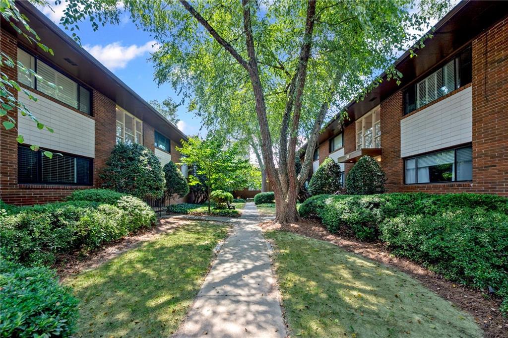 20 26th Street Northwest, Unit A1 Atlanta, GA 30309 - Photo 2 of 19 a backyard of a house with lots of green space