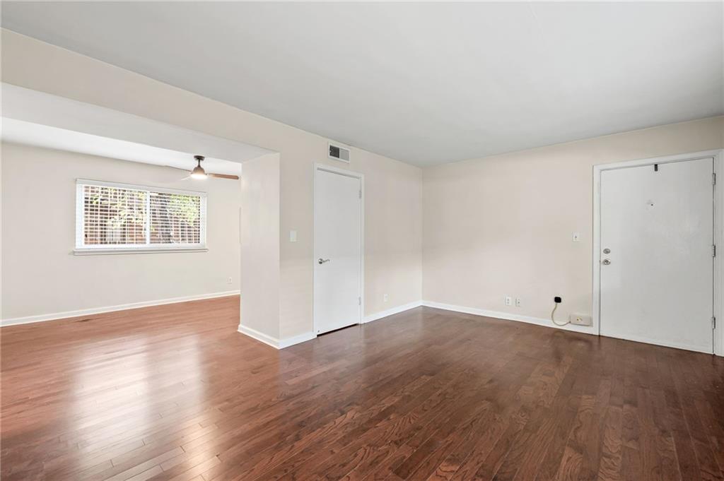 20 26th Street Northwest, Unit A1 Atlanta, GA 30309 - Photo 6 of 19 an empty room with wooden floor and windows