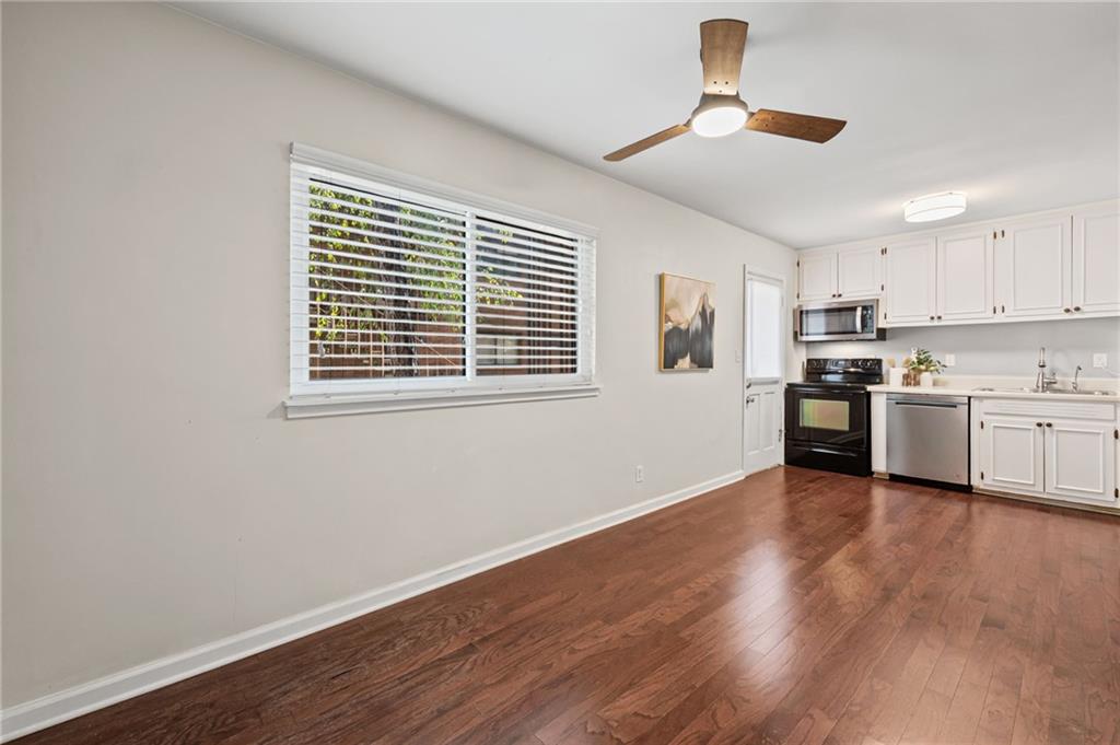 20 26th Street Northwest, Unit A1 Atlanta, GA 30309 - Photo 7 of 19 a view of an empty room with window and wooden floor