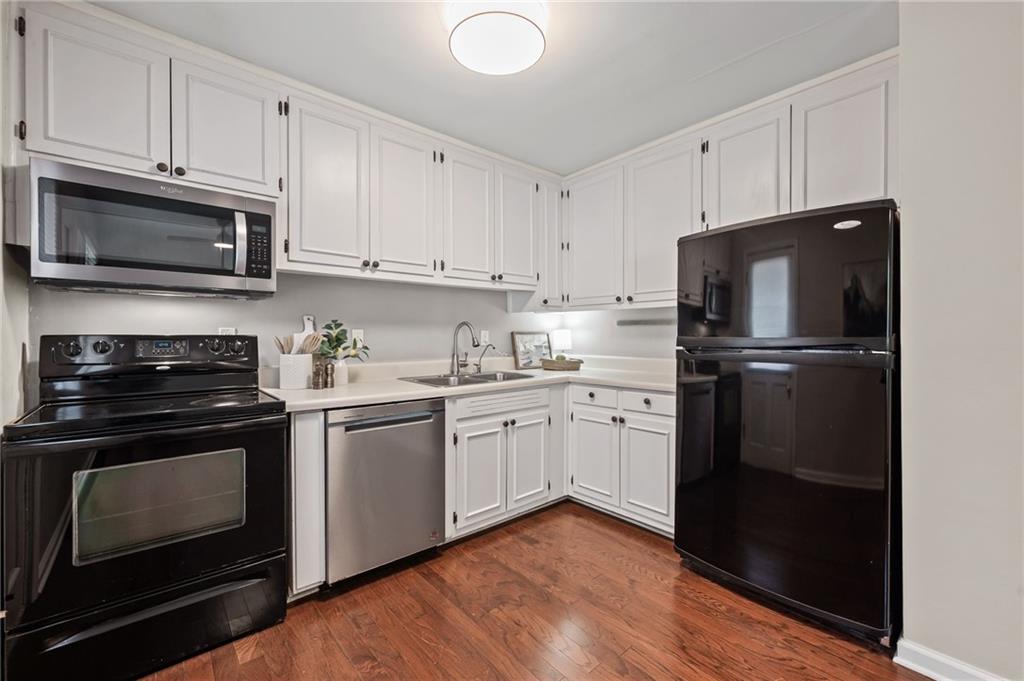 20 26th Street Northwest, Unit A1 Atlanta, GA 30309 - Photo 9 of 19 a kitchen with a refrigerator stove and white cabinets