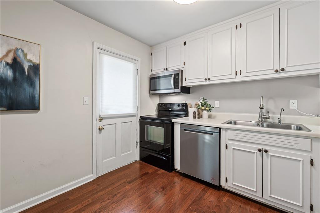 20 26th Street Northwest, Unit A1 Atlanta, GA 30309 - Photo 10 of 19 a kitchen with granite countertop white cabinets and stainless steel appliances