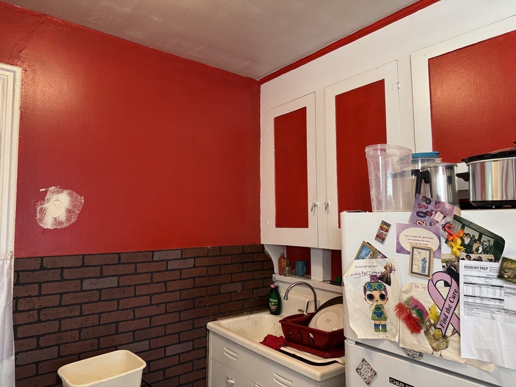 495 Warren Street Boston, MA 02121 - Photo 5 of 25 a bathroom with a toilet sink and mirror