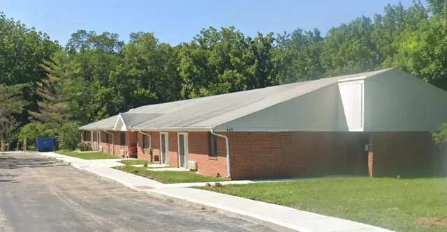 a patio with table and chairs and a yard