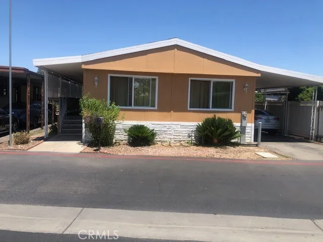 16600 Downey, Unit 115 Paramount, CA 90723 - Photo 1 of 15 a front view of a house with a yard and glass windows