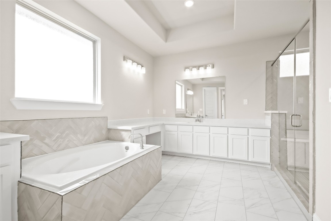 136 Peninsula Point Drive Montgomery, TX 77356 - Photo 11 of 30 a spacious bathroom with a tub a sink and mirror