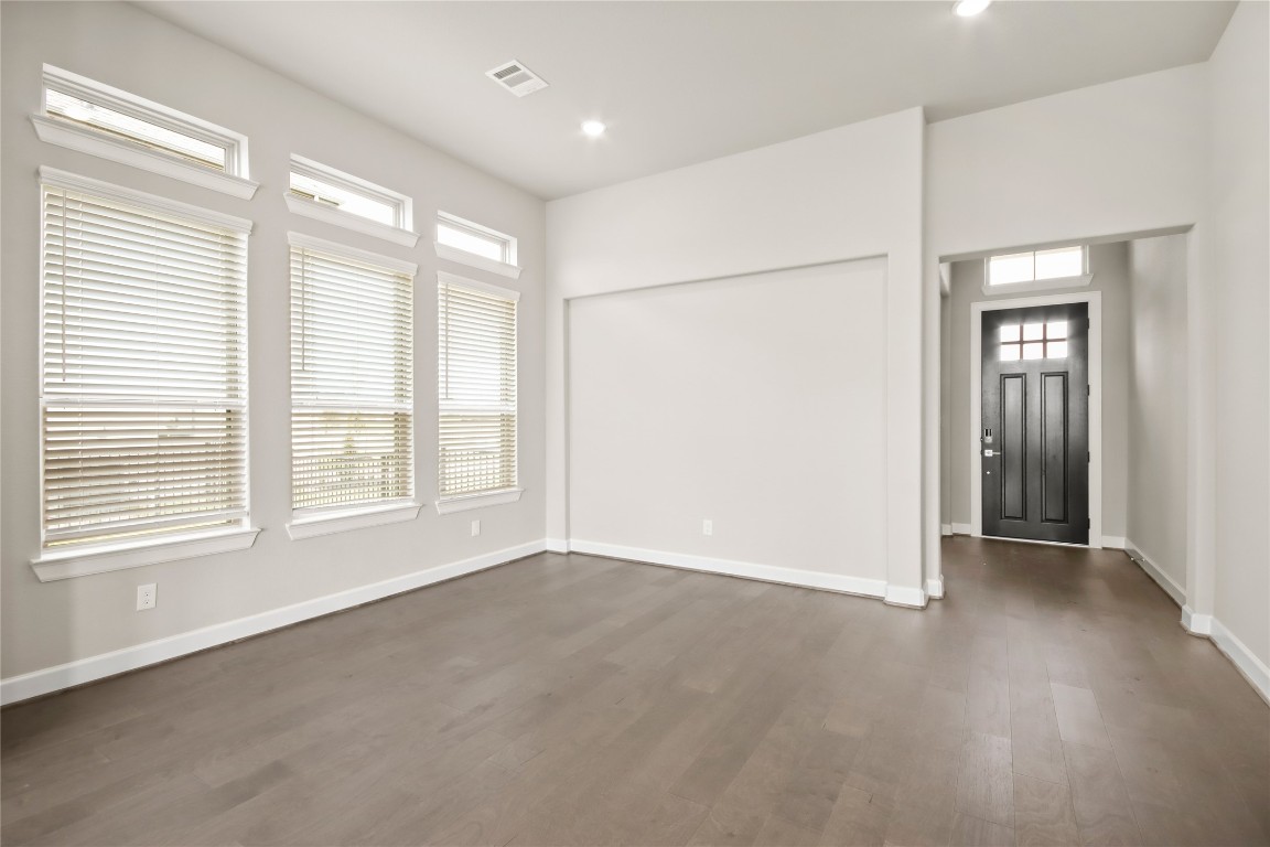 136 Peninsula Point Drive Montgomery, TX 77356 - Photo 4 of 30 a view of an empty room with wooden floor and a window