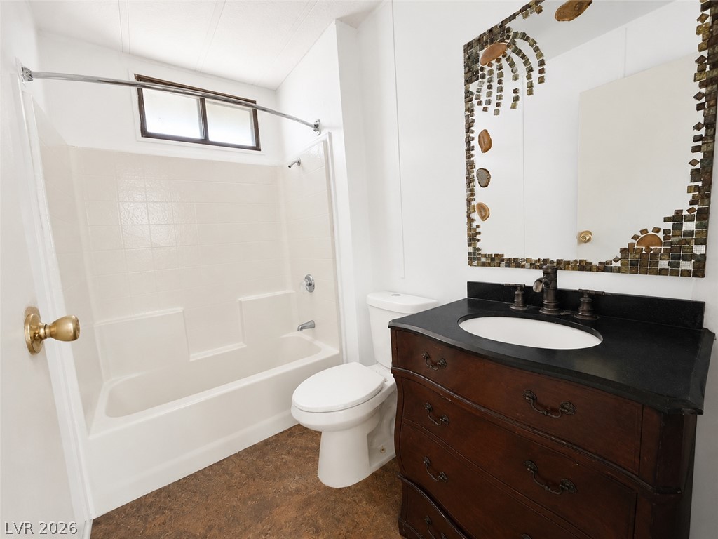 1611 West Blosser Ranch Road Pahrump, NV 89060 - Photo 16 of 25 A dark vanity and decorative mirror highlight this full bathroom, complete with a shower-tub combination.