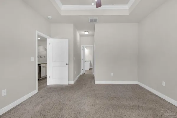 a view of an empty room and a bathroom