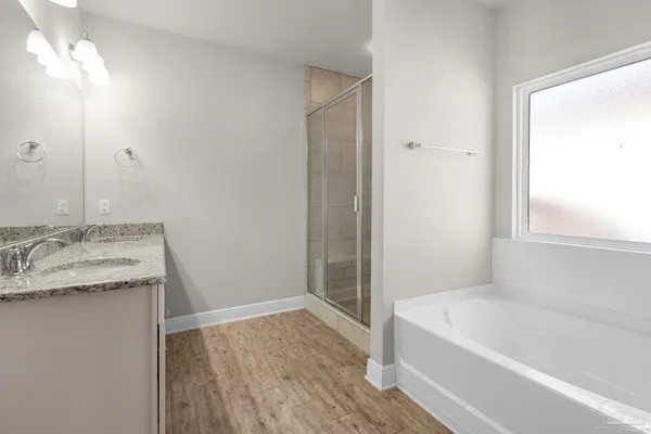 a bathroom with a granite countertop sink toilet and bathtub