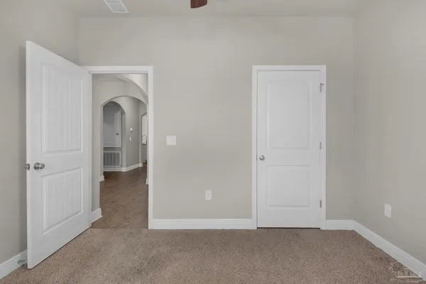 an empty room with closet area