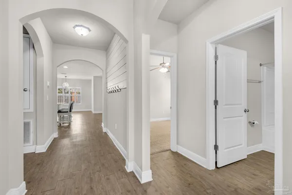 a view of a hallway view with wooden floor and staircase