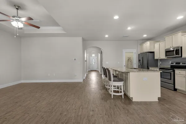 a kitchen with stainless steel appliances a refrigerator and a stove top oven
