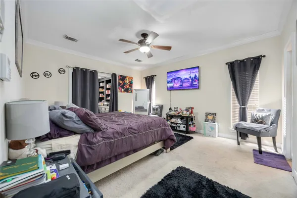 a spacious bedroom with a bed and a chandelier