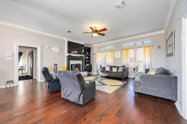 a living room with furniture kitchen view and a chandelier
