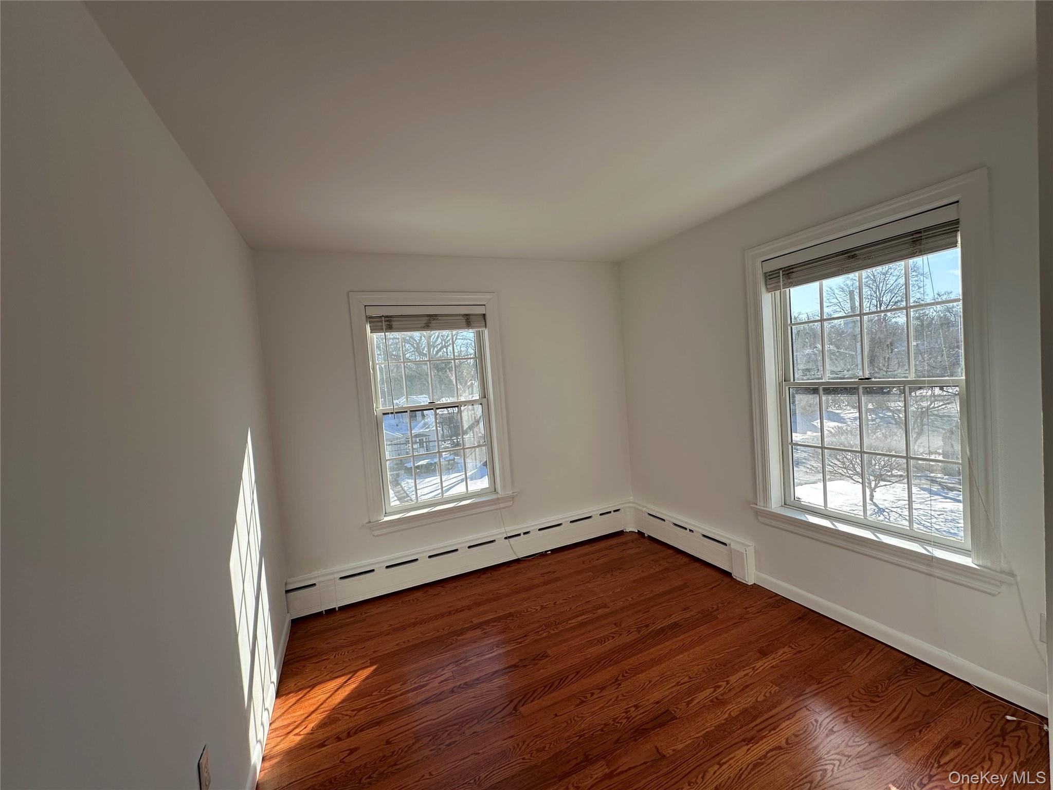 197 Johnson Road Scarsdale, NY 10583 - Photo 11 of 36 Bedroom featuring dark wood-type flooring and baseboard heating