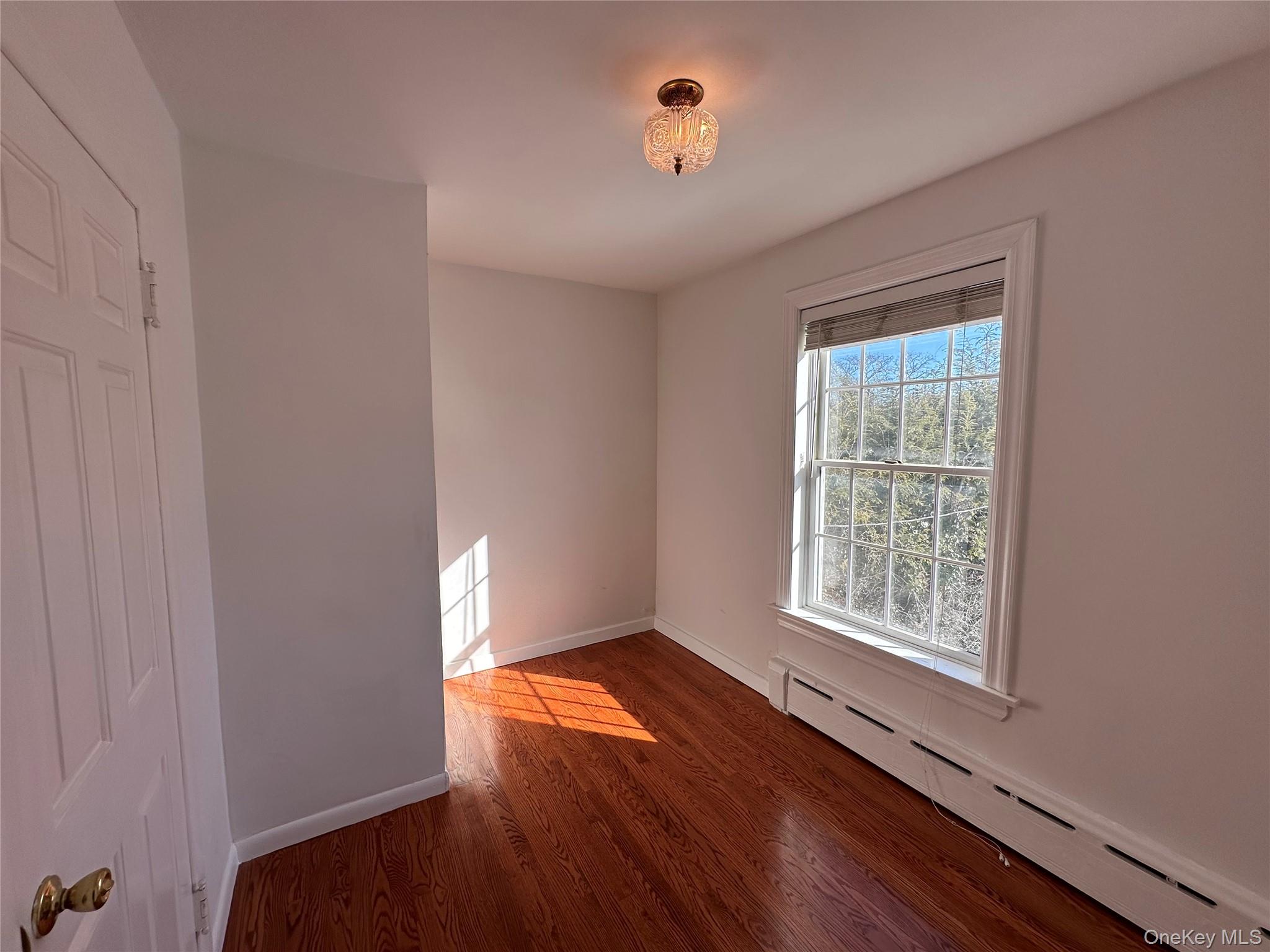 197 Johnson Road Scarsdale, NY 10583 - Photo 13 of 36 Bedroom with dark hardwood / wood-style floors and baseboard heating