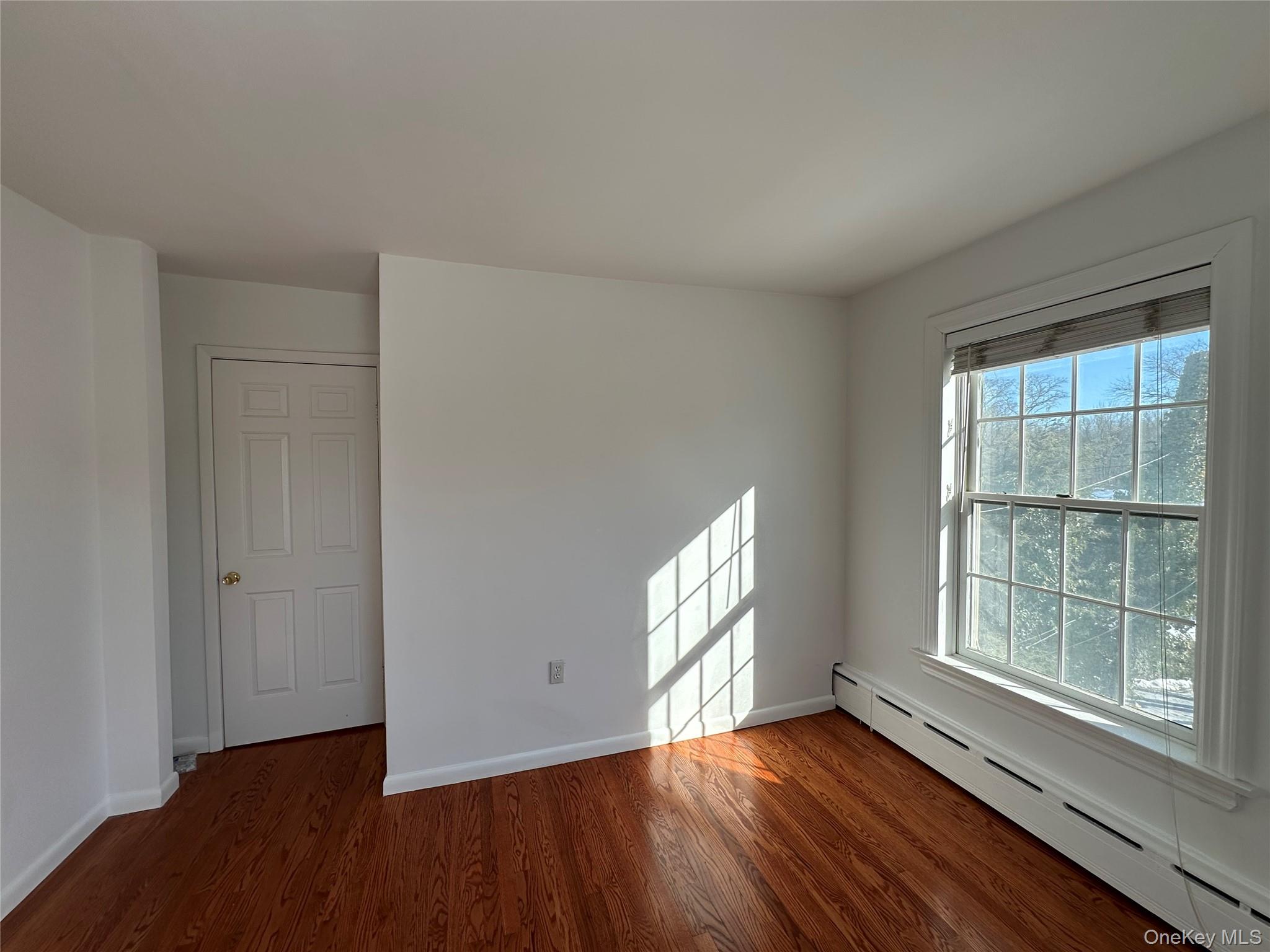 197 Johnson Road Scarsdale, NY 10583 - Photo 16 of 36 Unfurnished room featuring dark hardwood / wood-style flooring and baseboard heating
