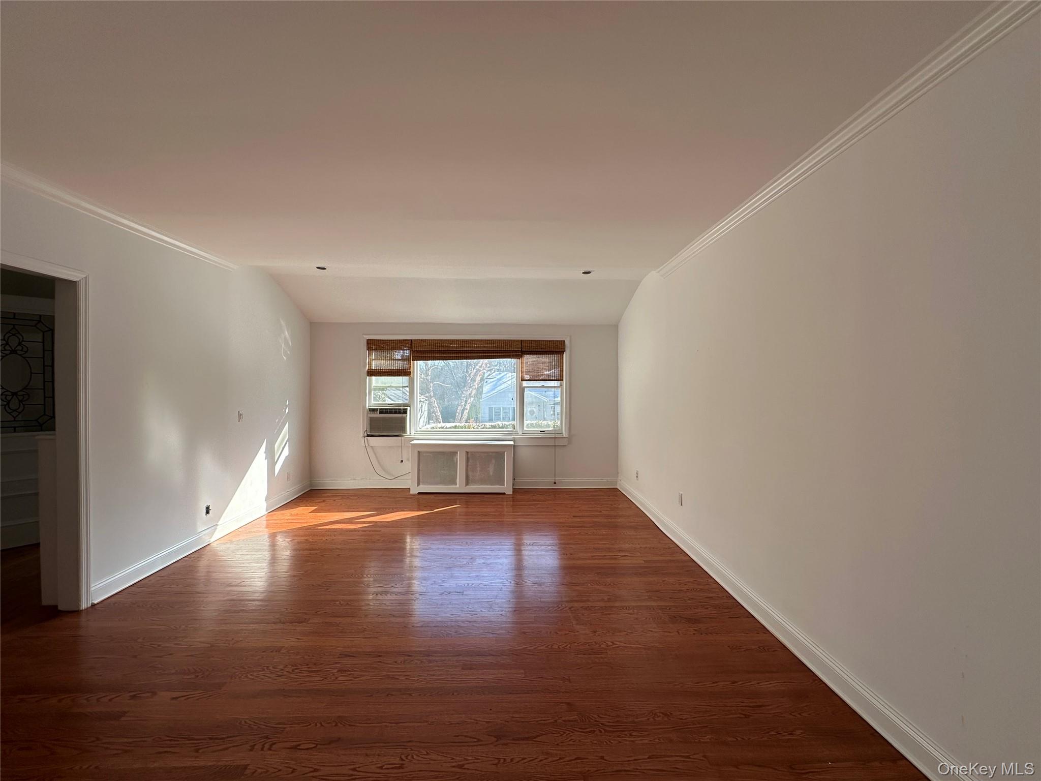 197 Johnson Road Scarsdale, NY 10583 - Photo 23 of 36 Living room featuring hardwood / wood-style flooring, ornamental molding, and radiator