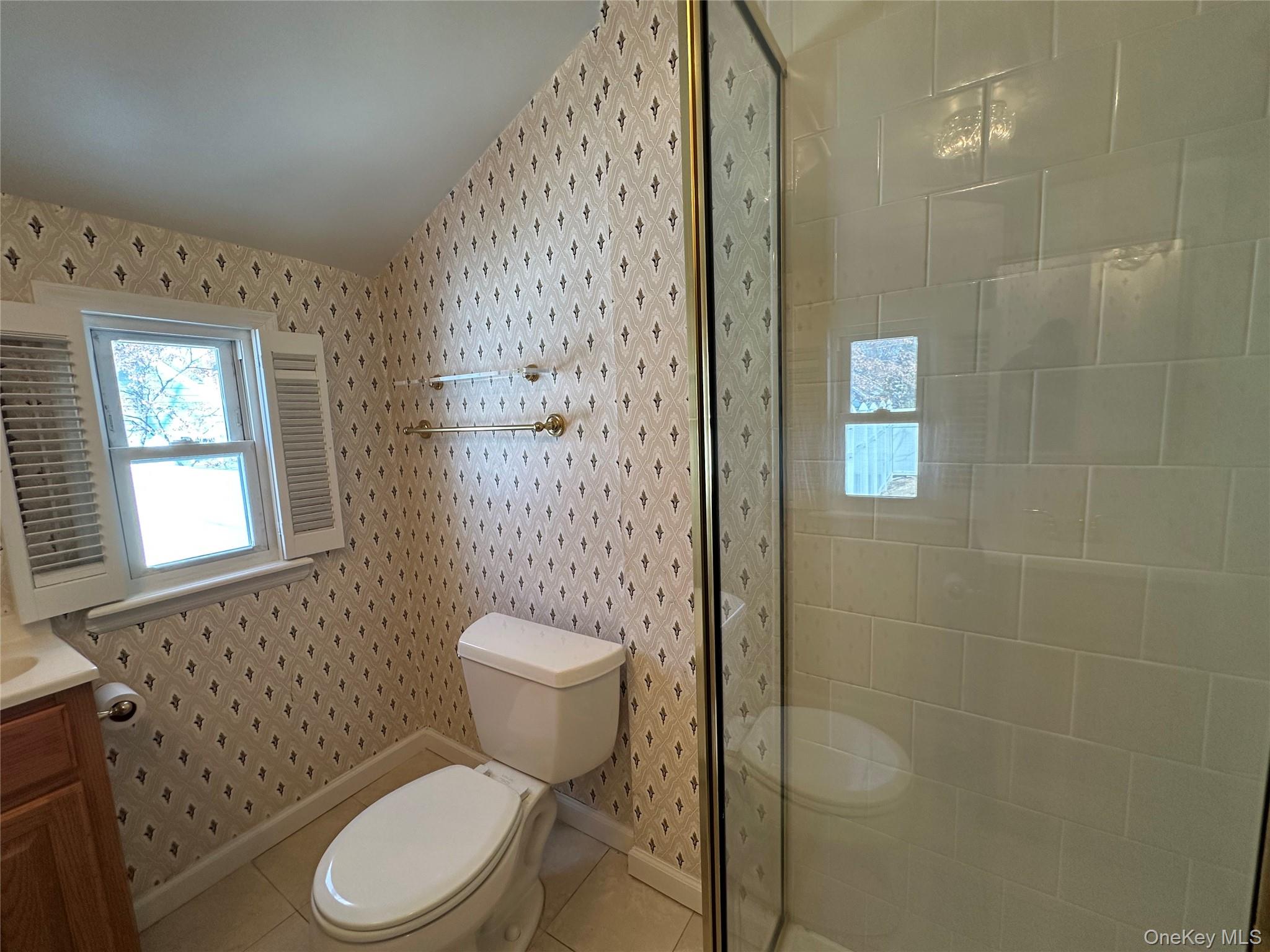 197 Johnson Road Scarsdale, NY 10583 - Photo 29 of 36 Bathroom with vanity, tiled shower, tile patterned floors, and toilet
