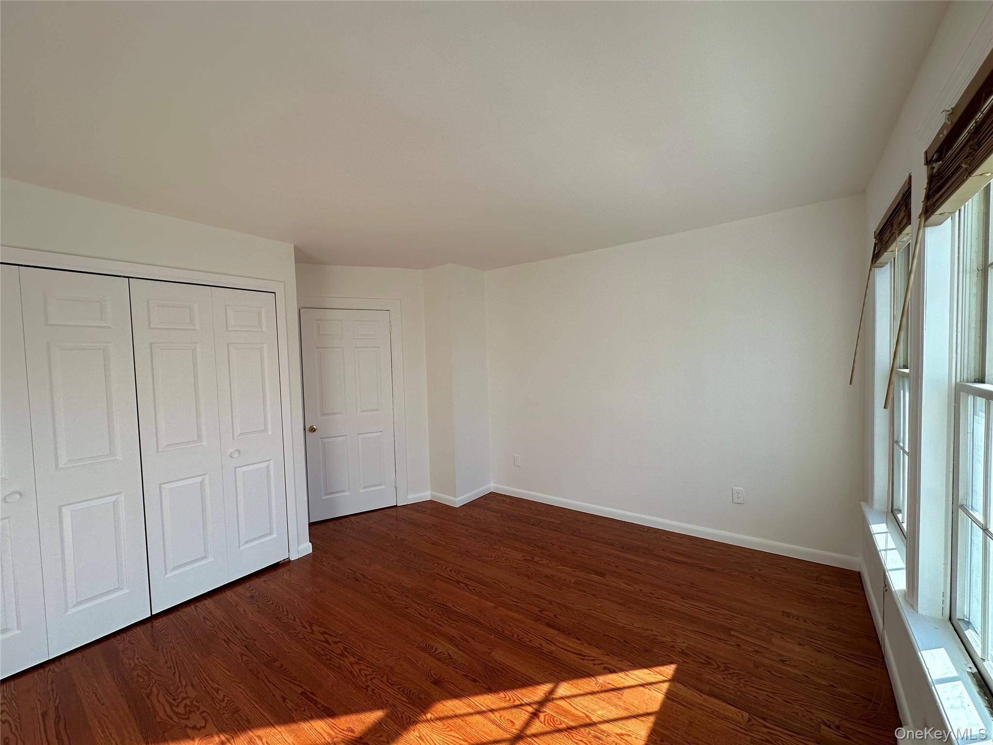 197 Johnson Road Scarsdale, NY 10583 - Photo 4 of 36 Unfurnished bedroom featuring dark hardwood / wood-style flooring and a closet