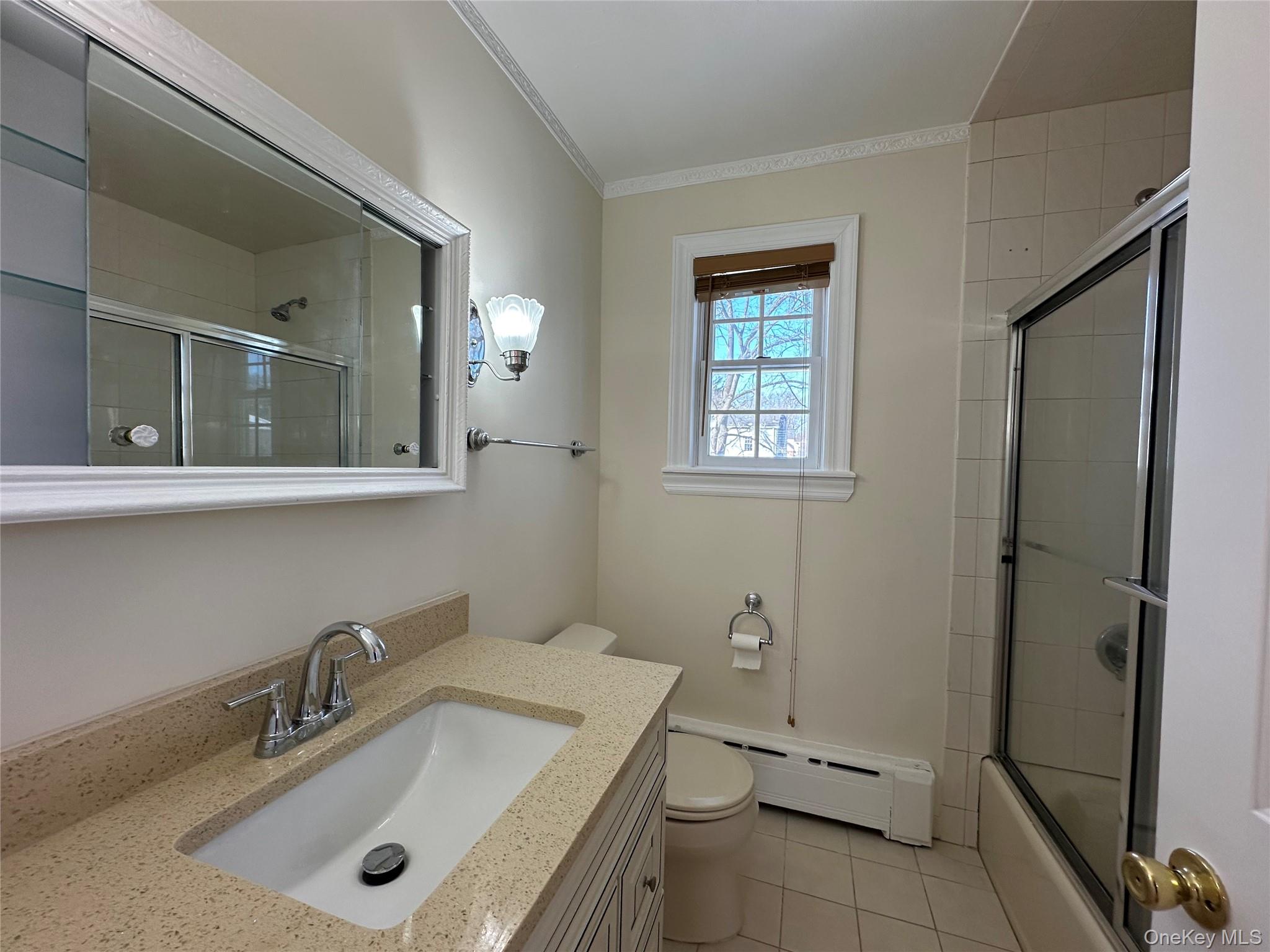 197 Johnson Road Scarsdale, NY 10583 - Photo 7 of 36 Full bathroom with toilet, baseboard heating, ornamental molding, vanity, and tile patterned flooring