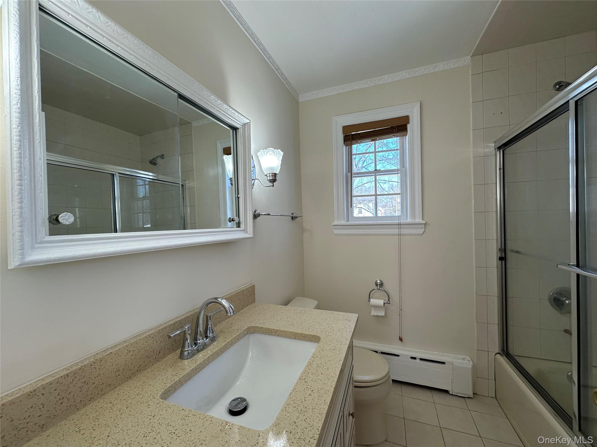 197 Johnson Road Scarsdale, NY 10583 - Photo 8 of 36 Full bathroom with toilet, vanity, enclosed tub / shower combo, tile patterned flooring, and a baseboard heating unit