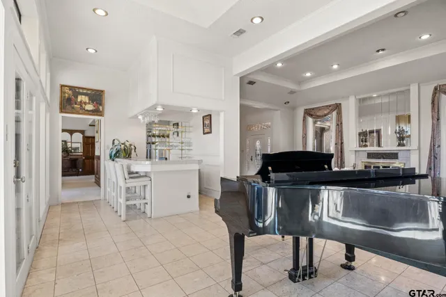 a kitchen with a dining table chairs and refrigerator