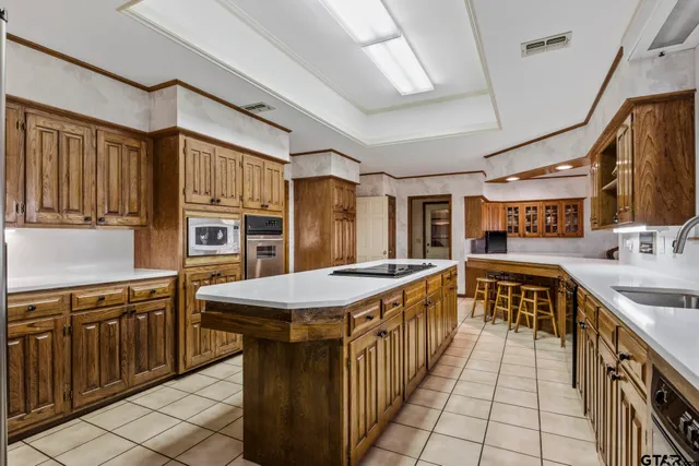 a kitchen with stainless steel appliances granite countertop a sink and a refrigerator