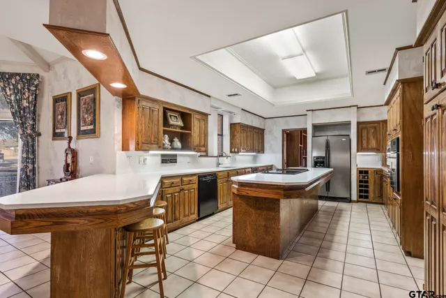 a kitchen with stainless steel appliances granite countertop a sink and cabinets