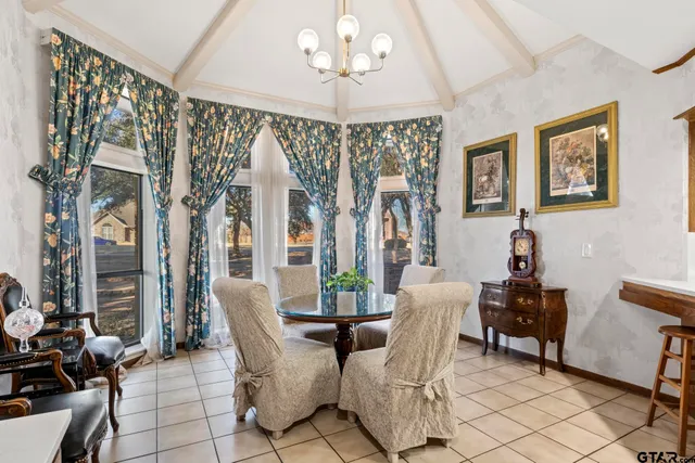 a living room with furniture a flat screen tv and a floor to ceiling window