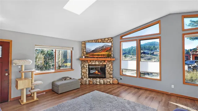 a living room with furniture fireplace and window