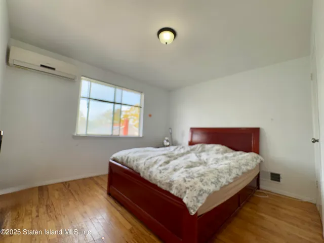 a bed sitting in a bedroom next to a window