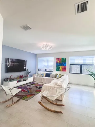 a bedroom with furniture and a flat screen tv