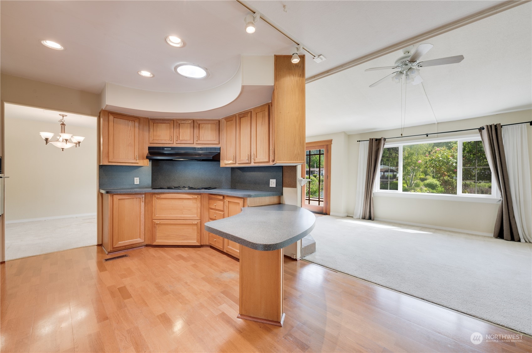 23803 Lake Drive West Bothell, WA 98021 - Photo 11 of 32 a large kitchen with a large window a sink and stainless steel appliances