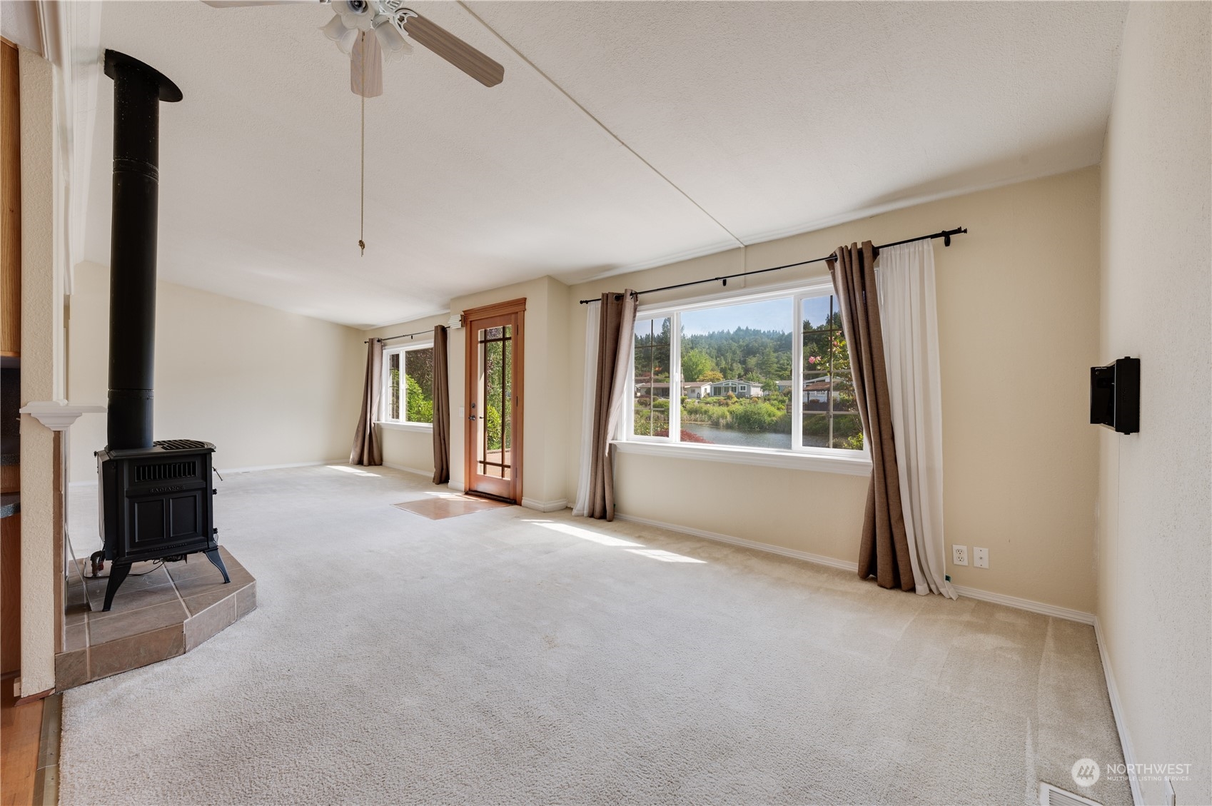 23803 Lake Drive West Bothell, WA 98021 - Photo 17 of 32 a view of a room with a floor to ceiling window and a flat screen tv