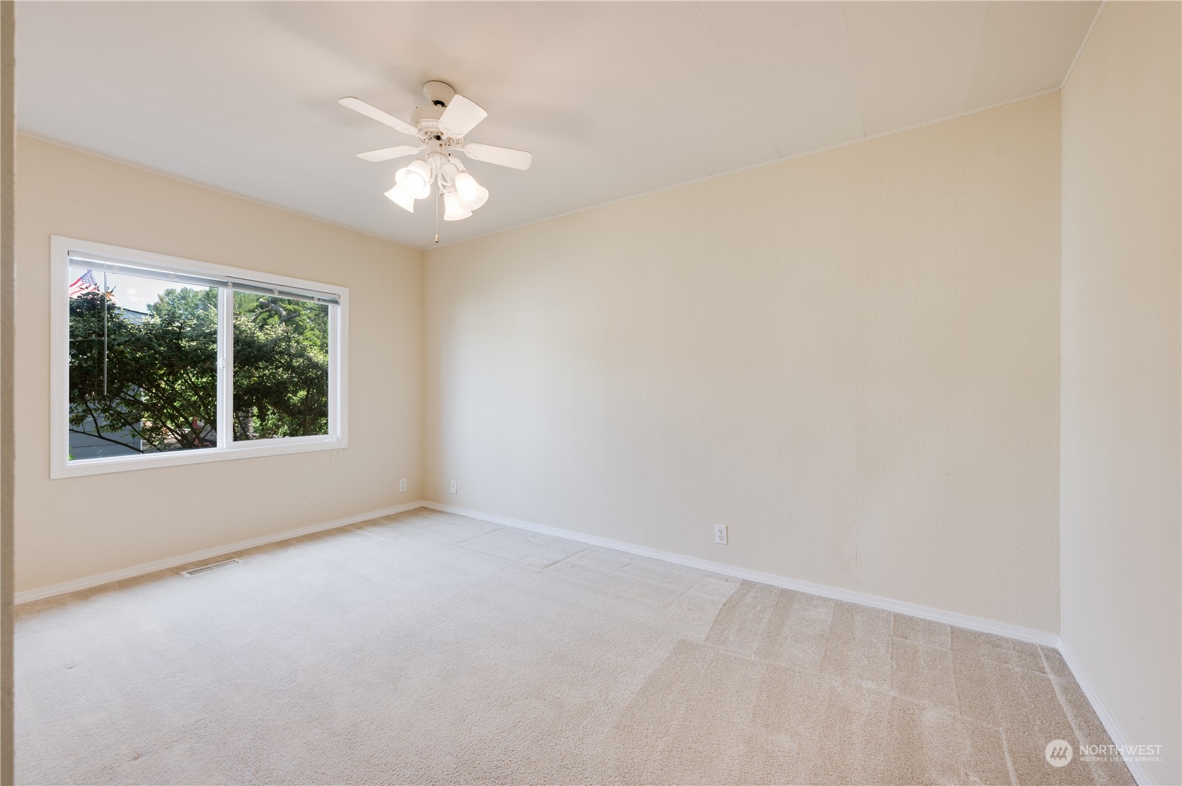 23803 Lake Drive West Bothell, WA 98021 - Photo 21 of 32 an empty room with a window and a fan