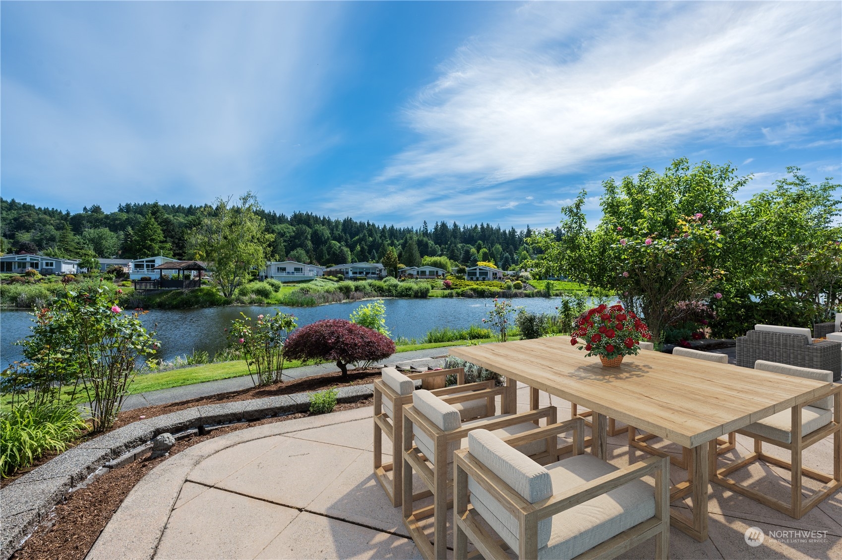 23803 Lake Drive West Bothell, WA 98021 - Photo 25 of 32 a view of a patio with table and chairs potted plants with wooden floor and lake view