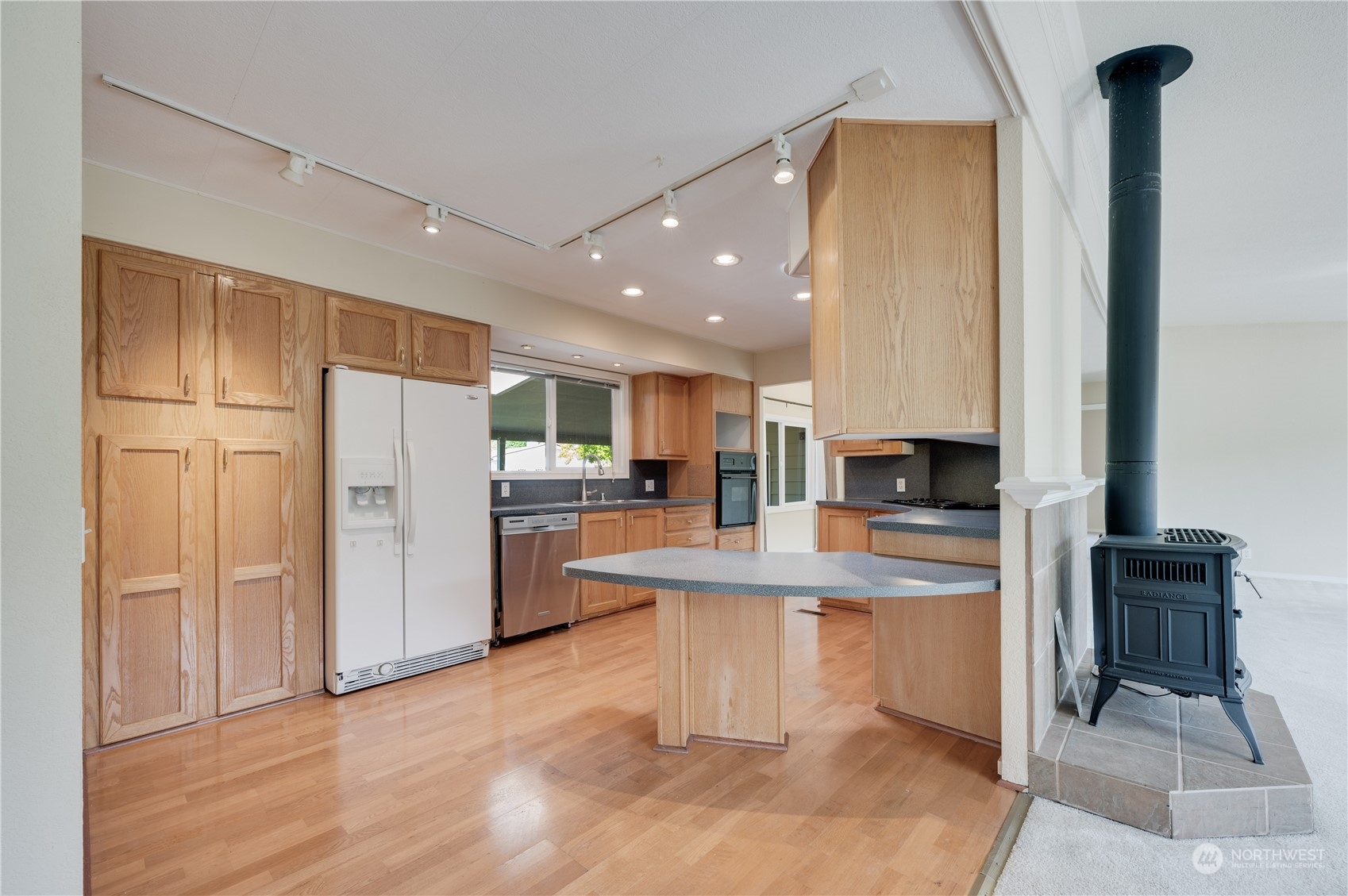 23803 Lake Drive West Bothell, WA 98021 - Photo 10 of 32 a kitchen with stainless steel appliances a refrigerator and a stove top oven