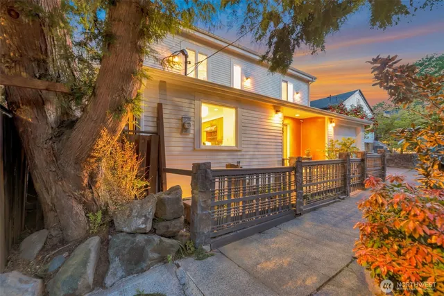 a view of a house with a large tree
