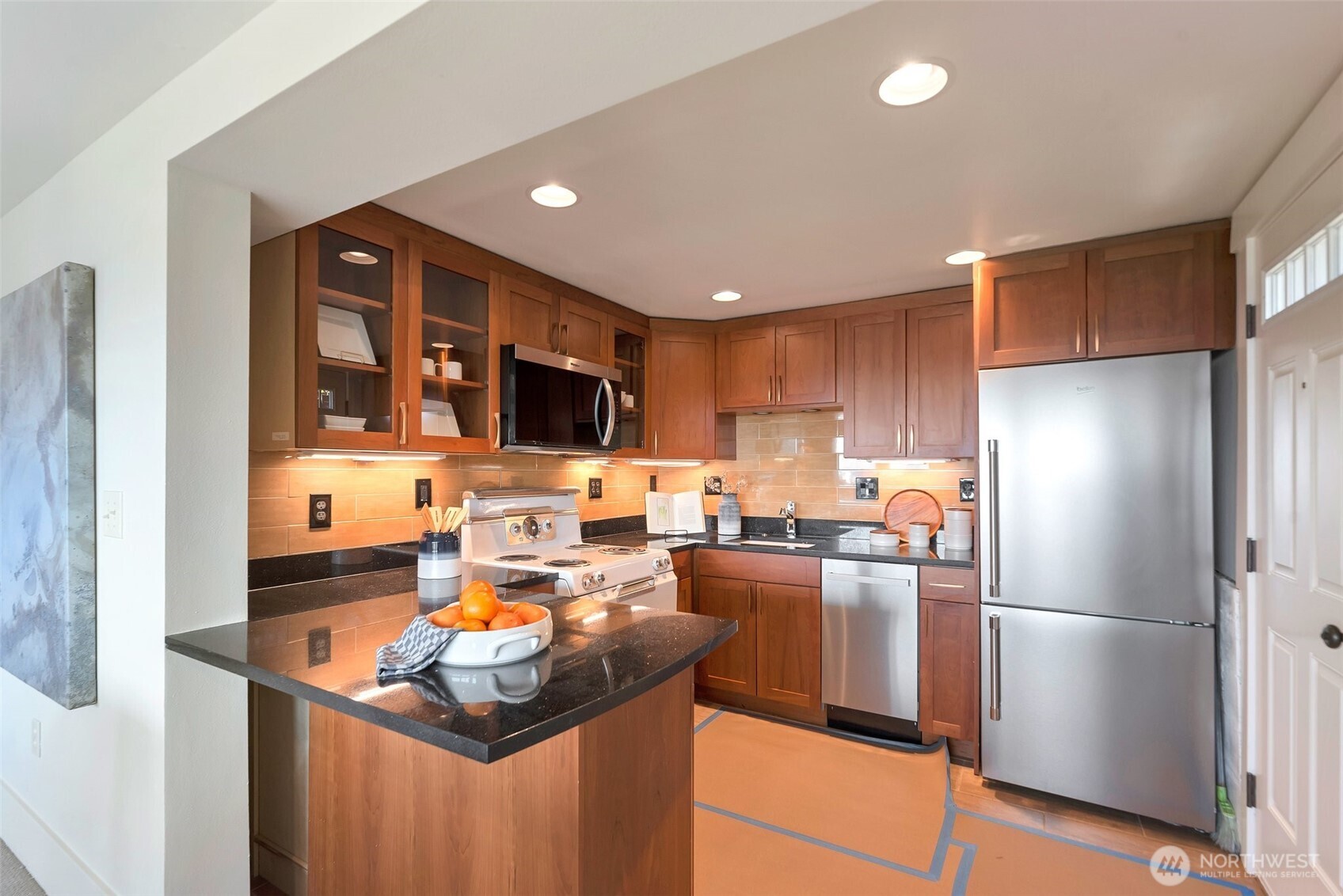 225 Ward Street Seattle, WA 98109 - Photo 23 of 36 a kitchen with a refrigerator a stove and a sink