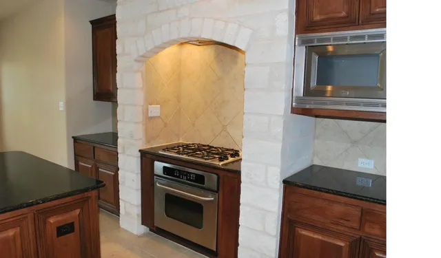 a kitchen with a stove and a microwave