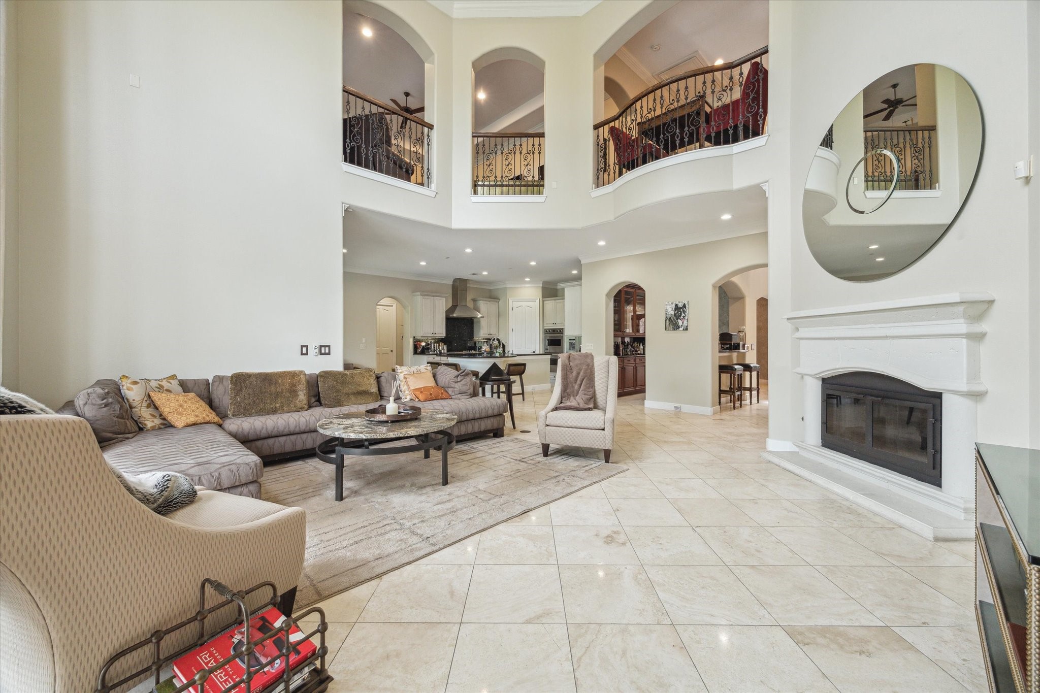 3319 Bridgeberry Lane Houston, TX 77082 - Photo 10 of 50 Two story family room with gas fireplace, stone floors and open balcony. Large two story windows overlooking the pool.