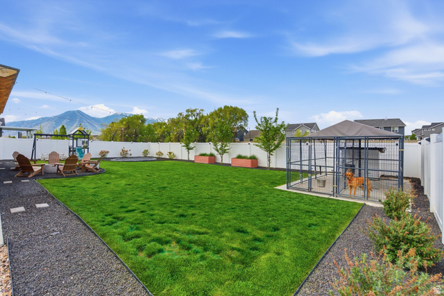 596 South Meade Street Mapleton, UT 84664 - Photo 29 of 38 Fenced backyard with an outbuilding, a mountain view, a patio, and an exterior structure